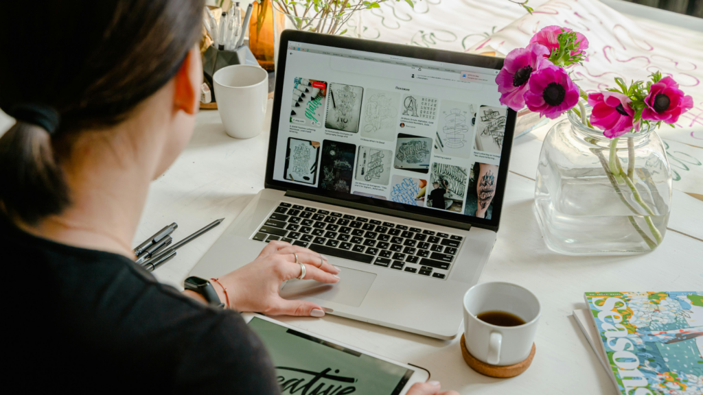 Set up your affiliate website A woman sitting in front of a laptop, setting up a website for affiliate marketing.