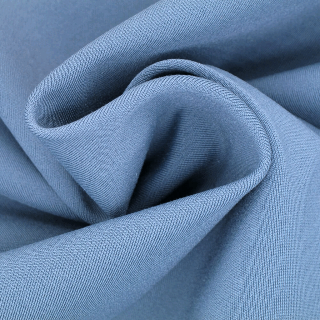 Spandex Types of fabric Close-up of light blue spandex with a visible weave pattern, twisted into a spiral shape.
