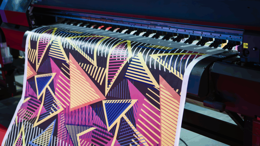 Sublimation printing Sublimation vs screen printing A large print machine displaying a vibrant print on its surface, showcasing its printing capabilities.