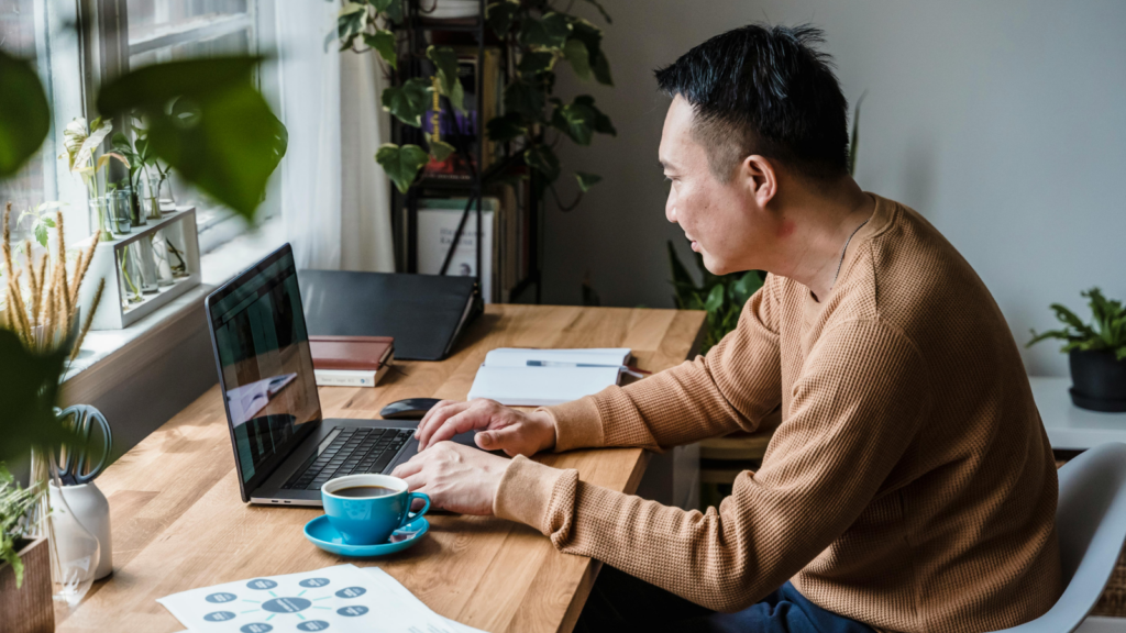 Tips for creating Shopify store names A person working from a home office using a laptop.