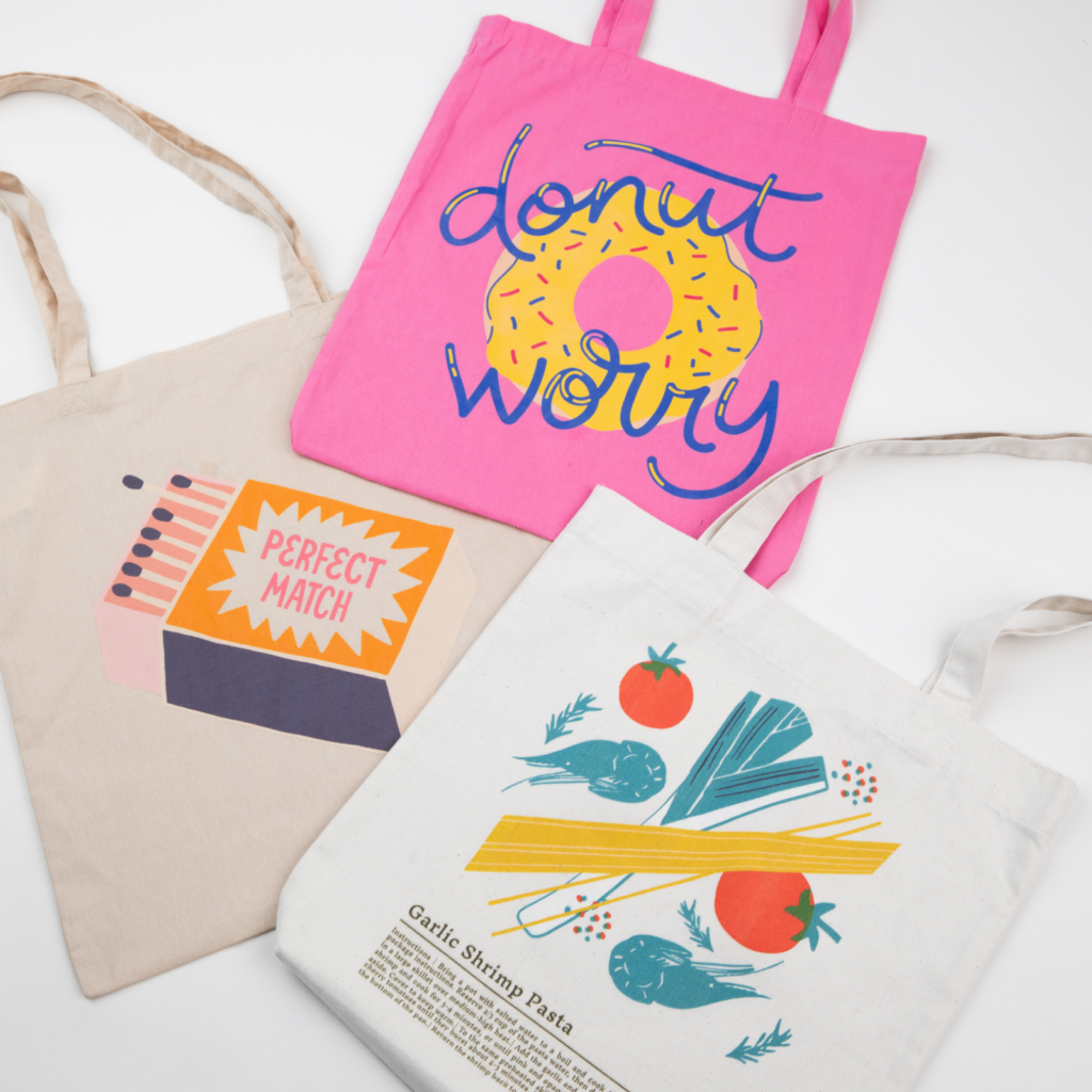 What to sell on Amazon with Print on Demand Three custom tote bags with different illustrated prints.