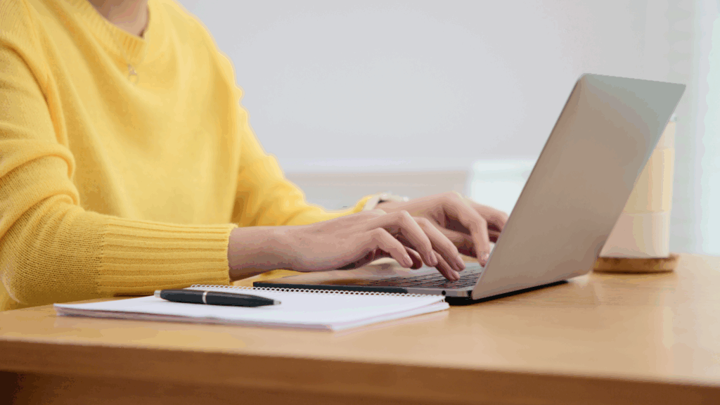 A woman typing on a keyboard.