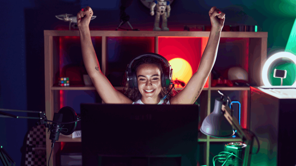 Become a streamer A woman wearing headphones sits at a laptop, focused on her work in front of a computer screen.