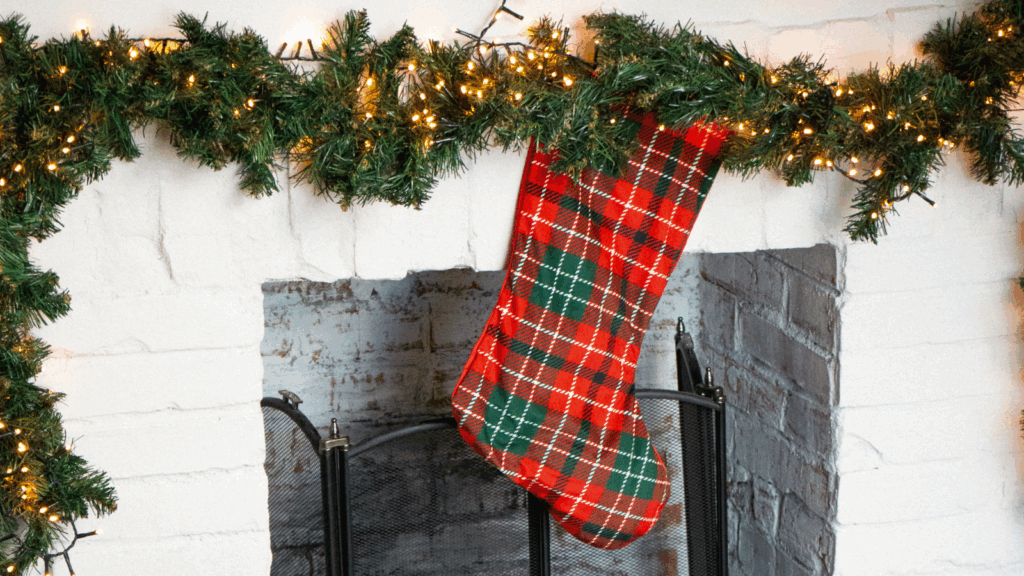 Christmas stockings Etsy shop ideas A red and green plaid stocking is displayed on a decorated fireplace mantle, adding a festive touch to the room.