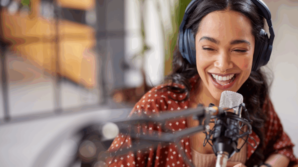 Collect LIVE gifts during video streams A smiling woman wearing headphones speaks into a microphone.