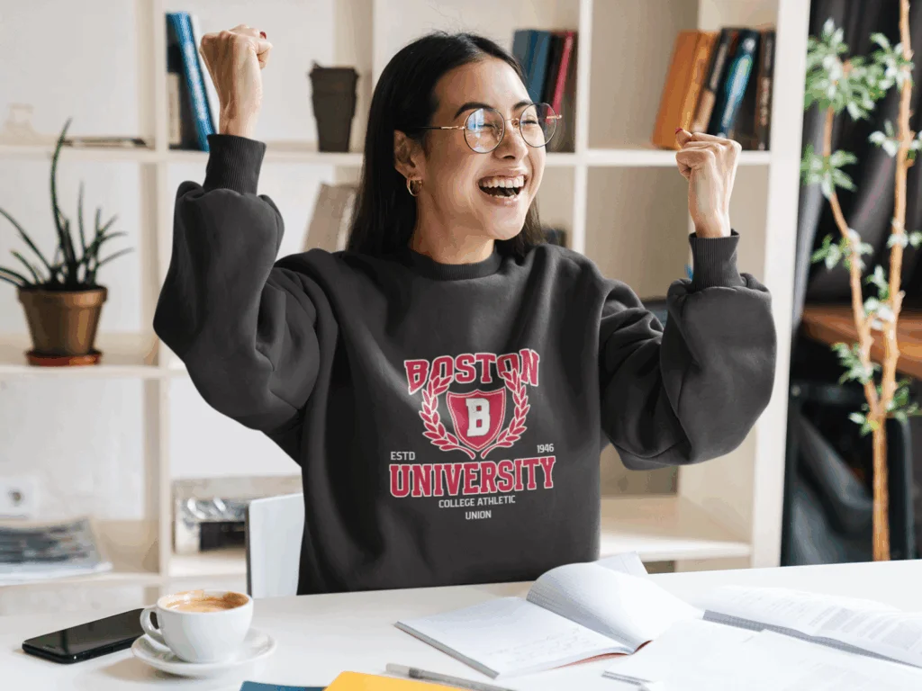 A smiling young woman in a “Boston University” college hoodie.