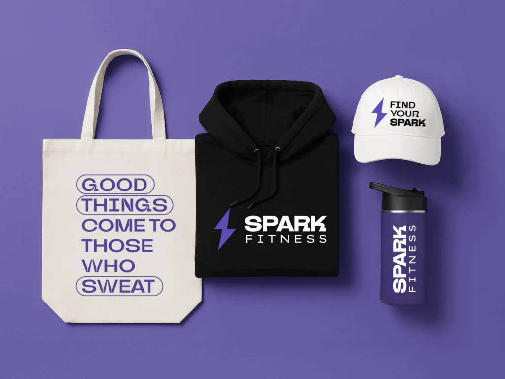 A tote bag, hoodie, white hat and water bottle with custom branding on a purple background.