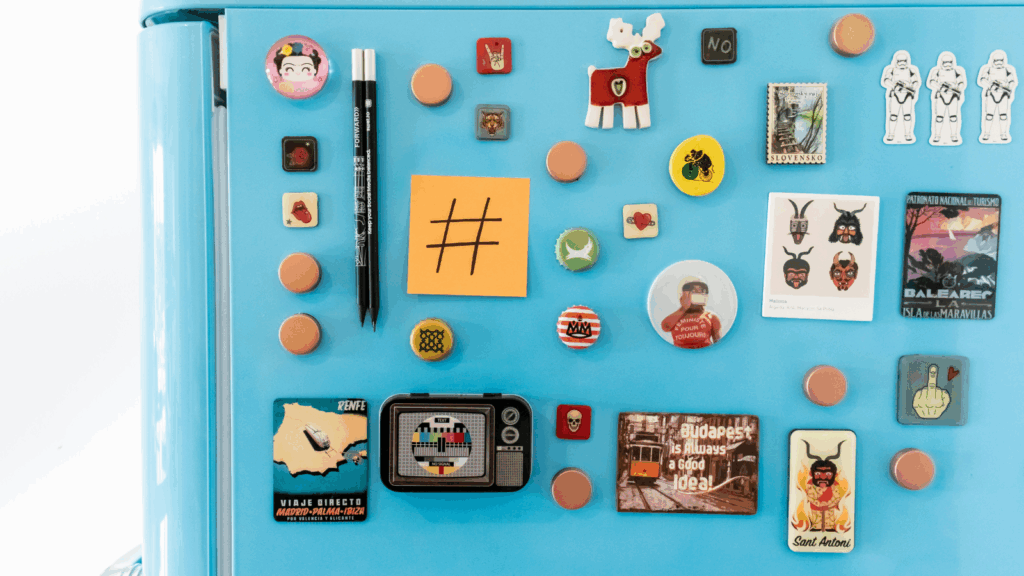 Magnets Etsy shop ideas A refrigerator adorned with colorful magnets and family pictures, showcasing personal memories and decorations.