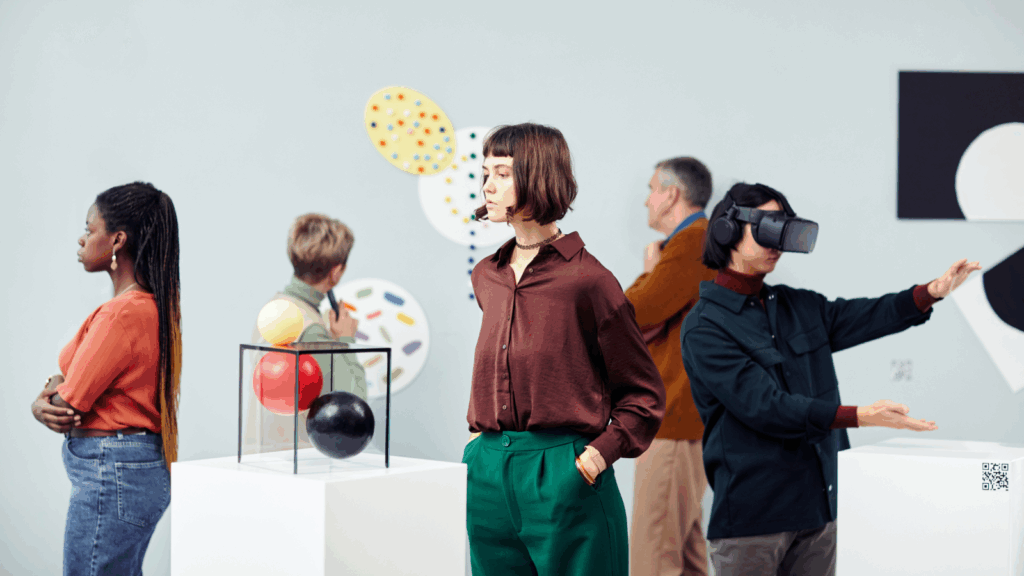 Medium types Several people are standing in an art gallery, looking at the exhibitions.