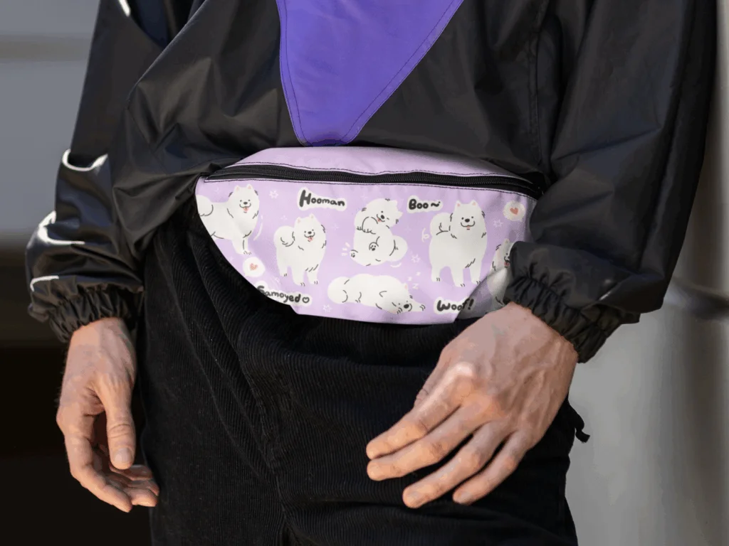 A man wearing a purple bum bag with a dog-themed print.