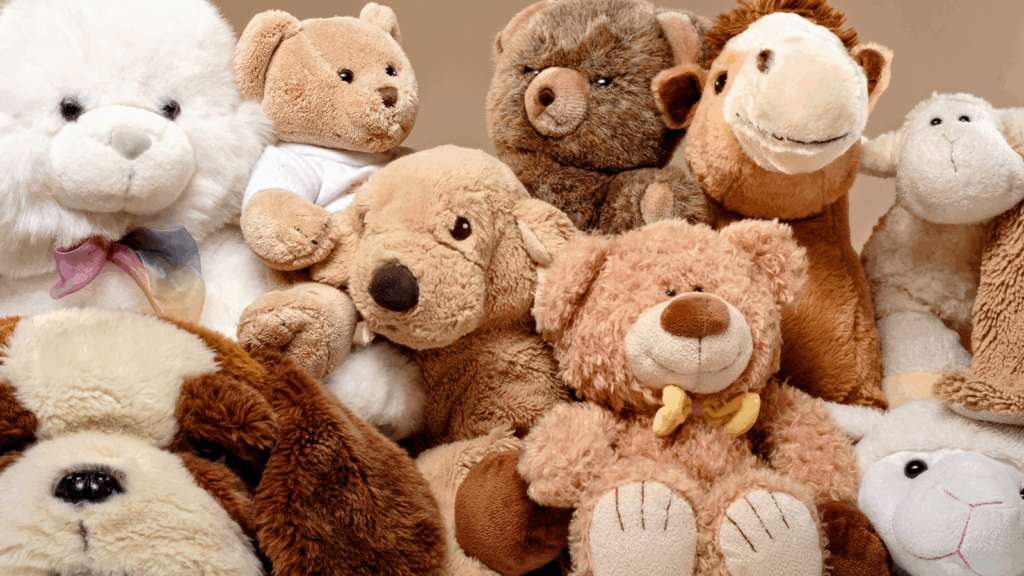 Plush toys Etsy shop ideas A group of colorful stuffed animals sitting together on a soft surface, showcasing their various shapes and sizes.