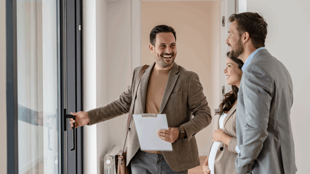 Rent out your space – Monetize a room or garage A man showing an apartment for a couple.
