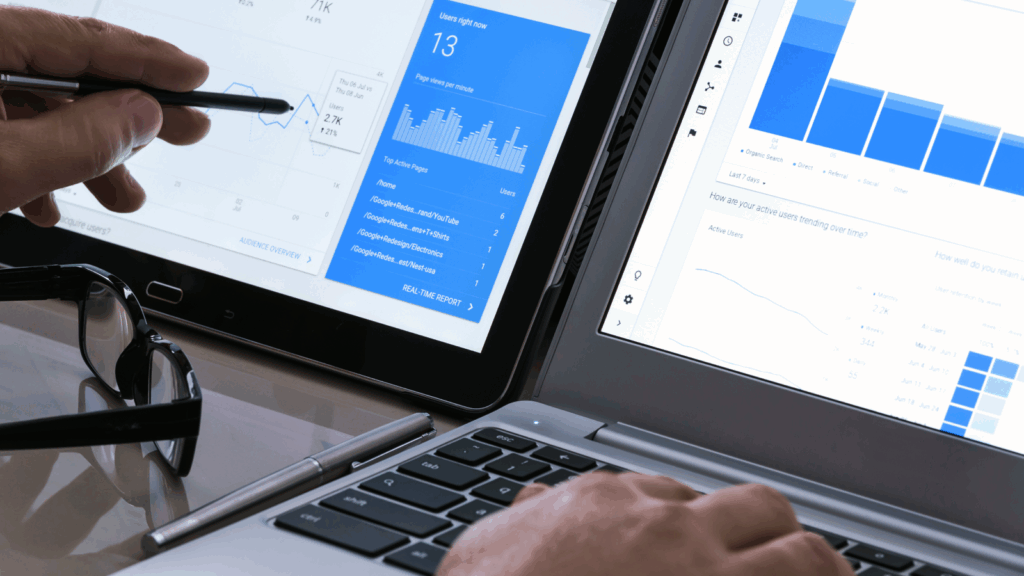 A person working on a laptop displaying a graph, focused on data analysis or presentation.