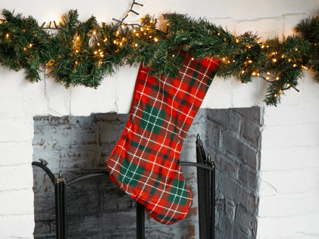 A Christmas stocking hanging above a fireplace.
