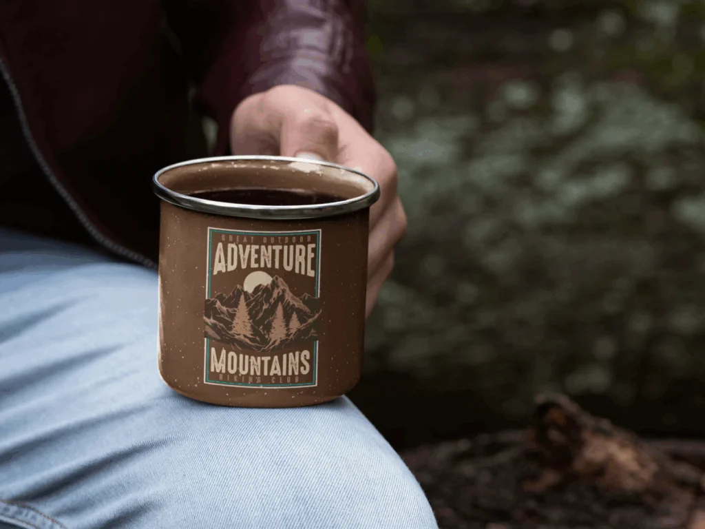 A custom enamel mug with a mountain hiking-themed print.