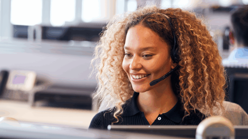 Transcription services – Convert audio into text A woman wearing a headset, focused on her work in a modern office environment.