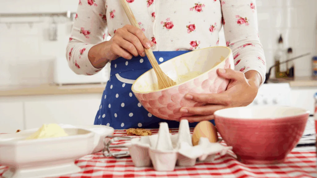 A woman is mixing ingredients for baking.
