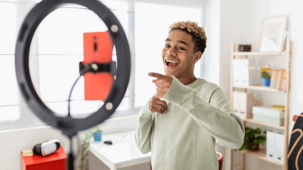 A content creator is filming himself using a mobile phone.