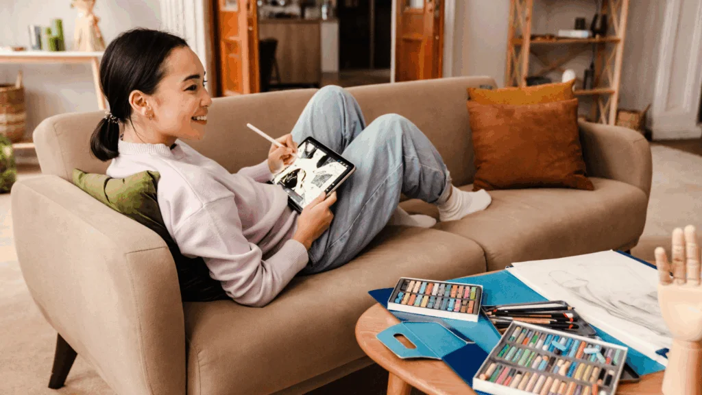 A woman artist is using a tablet to create a new piece of art to sell on Amazon.