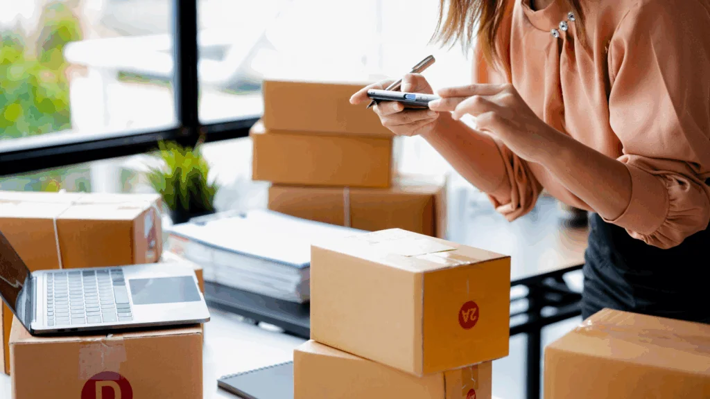 A woman is taking pictures of delivery boxes using a mobile phone.