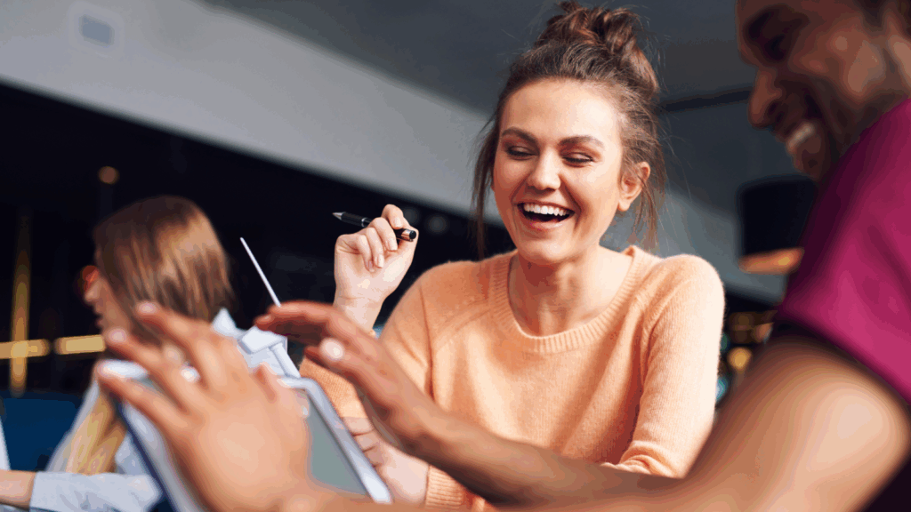 A smiling woman playing 4th of July trivia.
