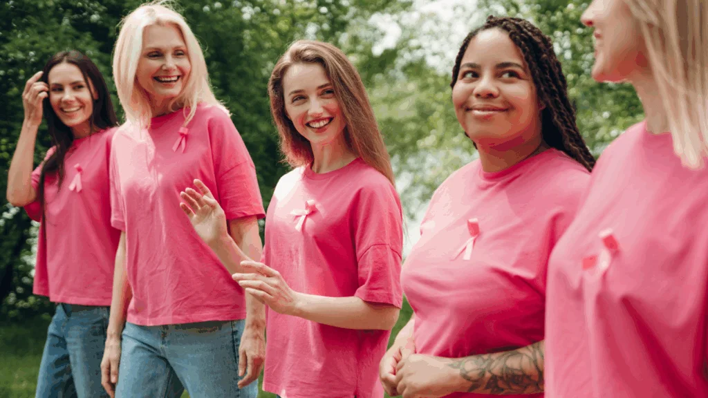 A group of women wearing pink t-shirts as part of a fundraising event.