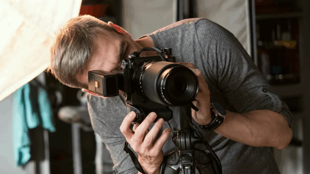 A photographer is taking a picture using a DSLR camera.