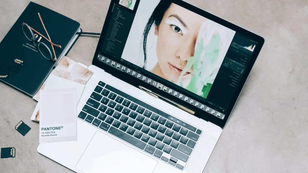 A close-up shot of a laptop with photo editing software on the screen.