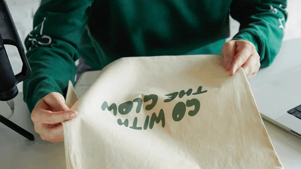 A woman holding a tote bag, showcasing a casual and eco-friendly lifestyle.