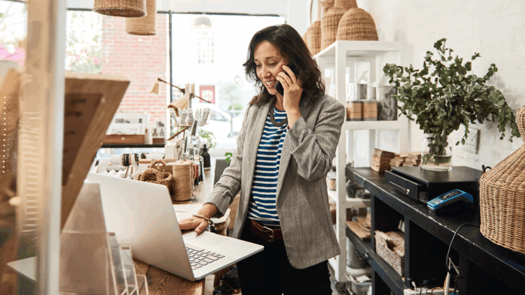 How can online retailers prepare for Cyber Monday and Black Friday A woman is talking to someone over the phone while using a laptop.