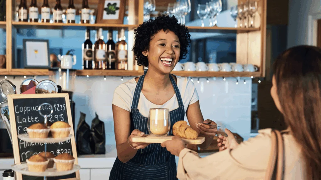 A woman presents a tray of food to another woman, sharing a moment of hospitality and connection.