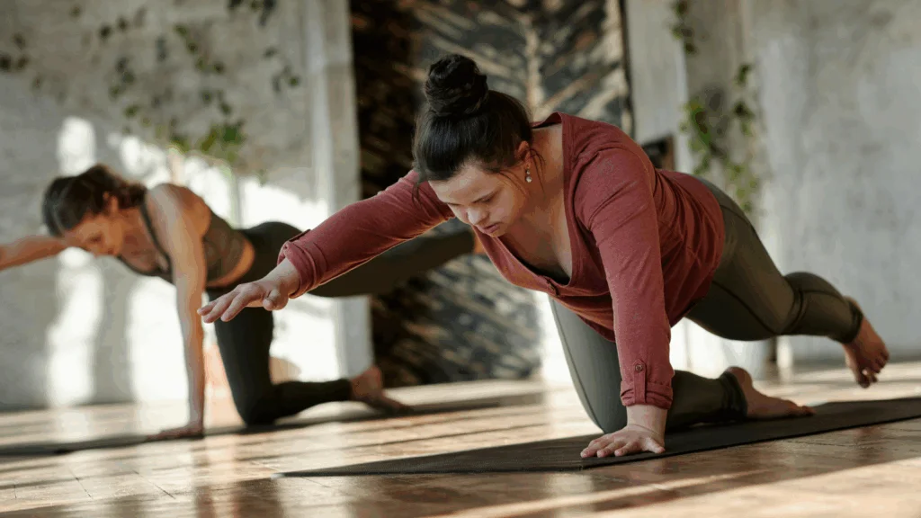 Two women engaged in yoga poses in a serene room, surrounded by calming decor and soft lighting.