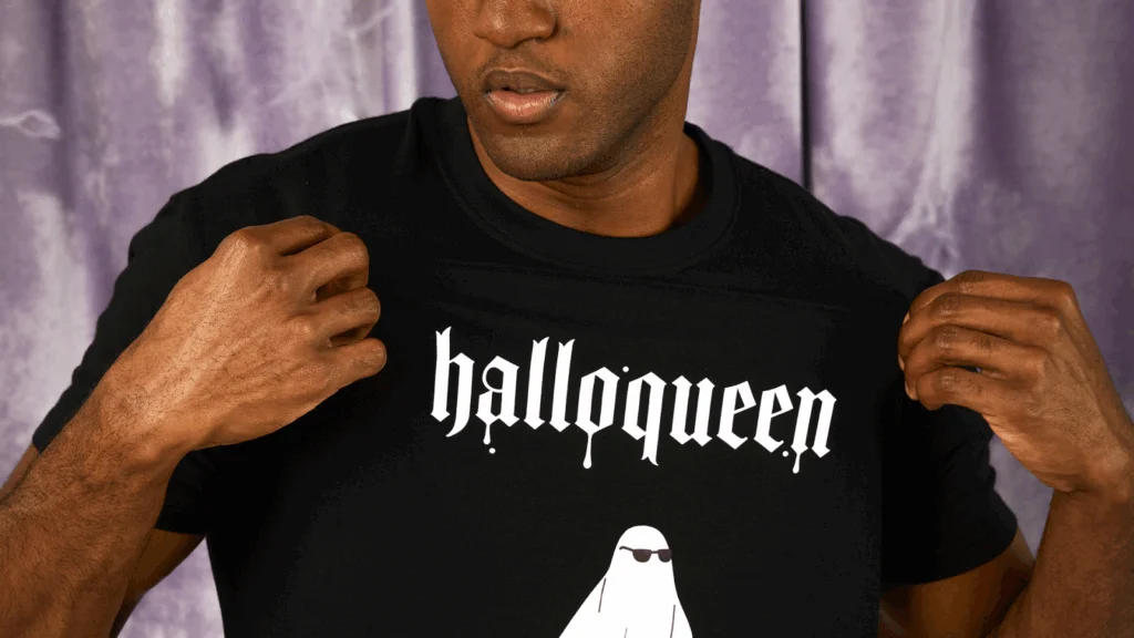 A man wearing a black Halloween-themed t-shirt.