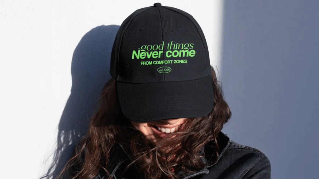 A woman wearing a hat with the phrase displayed prominently on the front.