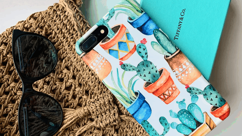 Phone case featuring a vibrant cactus print, showcasing various green cacti against a light background.