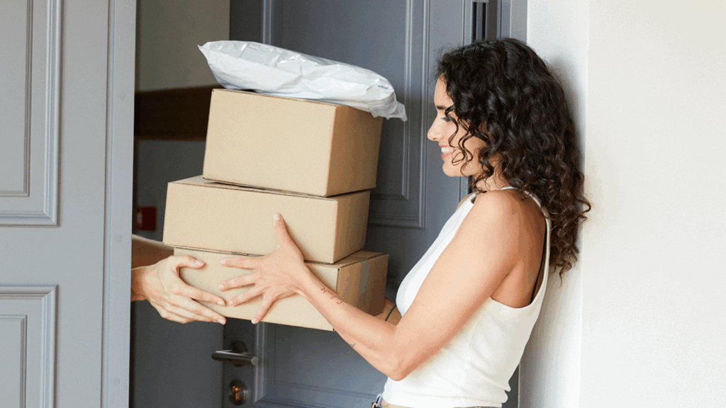 Shipping carrier support A woman and a man are both holding a box together, demonstrating teamwork and collaboration.