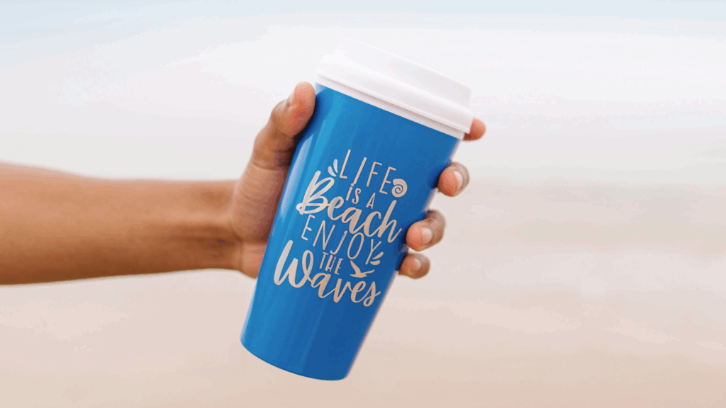 Travel inspired designs Tumbler design ideas Hand holding a blue travel mug mockup against a neutral background, showcasing its design and color.
