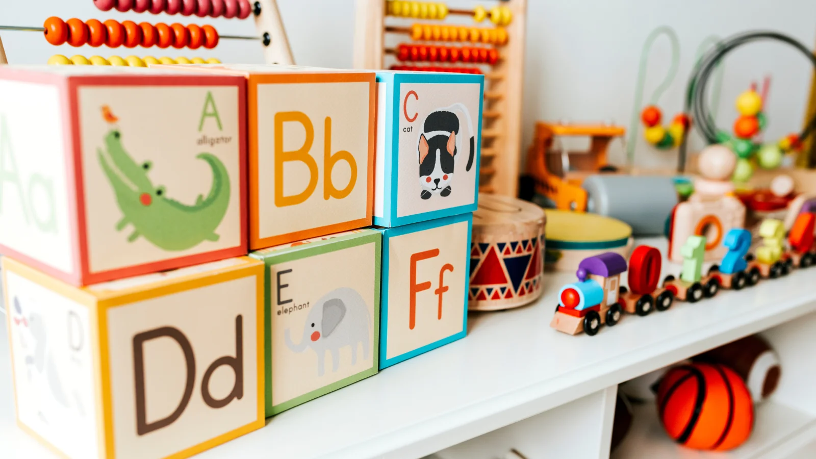 A colorful child's toy shelf filled with wooden blocks and various toys arranged neatly for playtime.