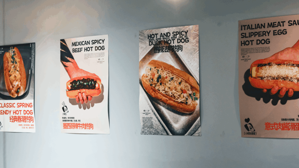 A wall covered with various food posters showcasing different dishes and culinary styles.