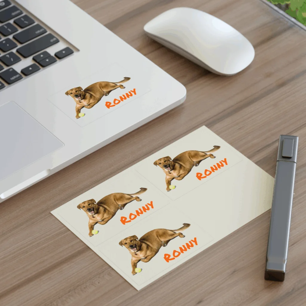 A laptop adorned with a colorful dog sticker on its surface