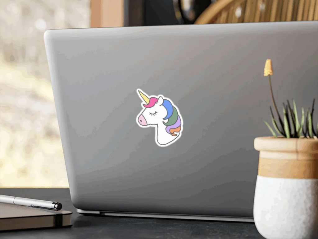 A laptop adorned with a colorful unicorn sticker on its cover, showcasing a whimsical design