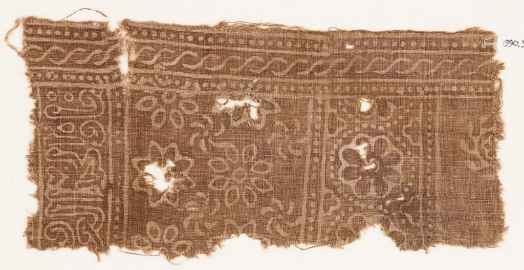 Textile fragment with rosettes and inscription