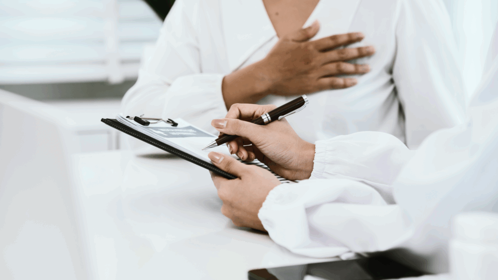 Product reviews and social proof Best Shopify apps A person writes on a clipboard while a woman sits at a desk, engaged in a consultation.