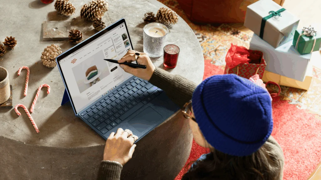 A person is working on a laptop in a festive environment.