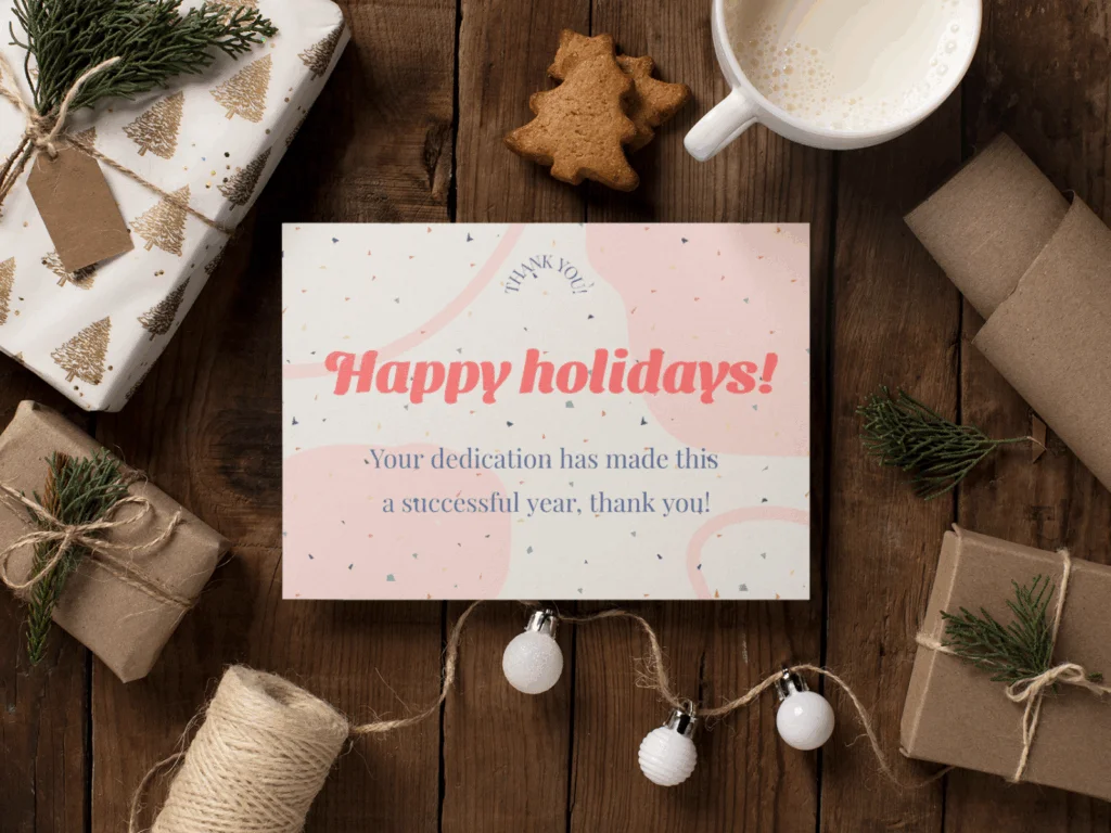 Mockup of a holiday greeting card featuring festive designs and colors, displayed on a wooden surface.