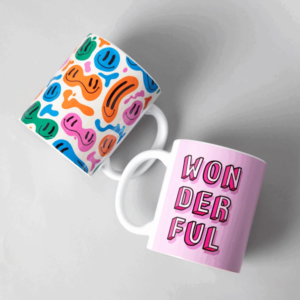 Two coffee mugs, one displaying the word "wonderful" printed on in a playful font.
