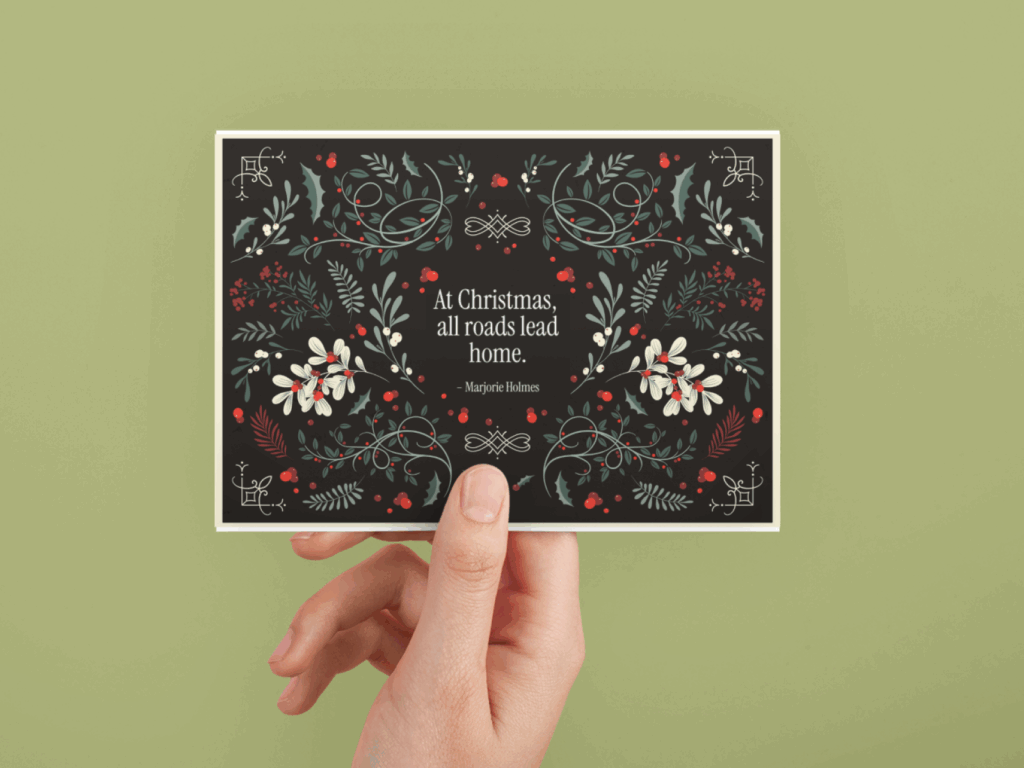 A hand holds a card featuring a vibrant floral design against a neutral background.