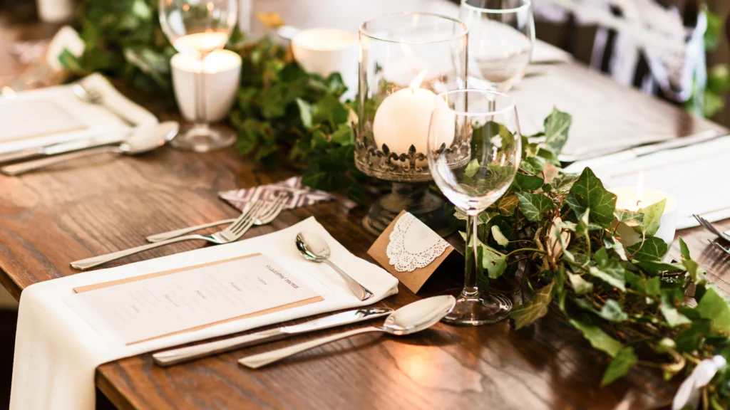 4 Wedding and bridal products A beautifully set table with elegant place settings and flickering candles, creating a warm and inviting atmosphere.