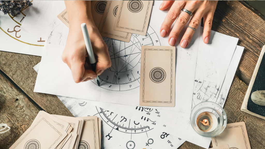 Astrology and spirituality A person writes on a piece of paper with a pen, focusing intently on their task.