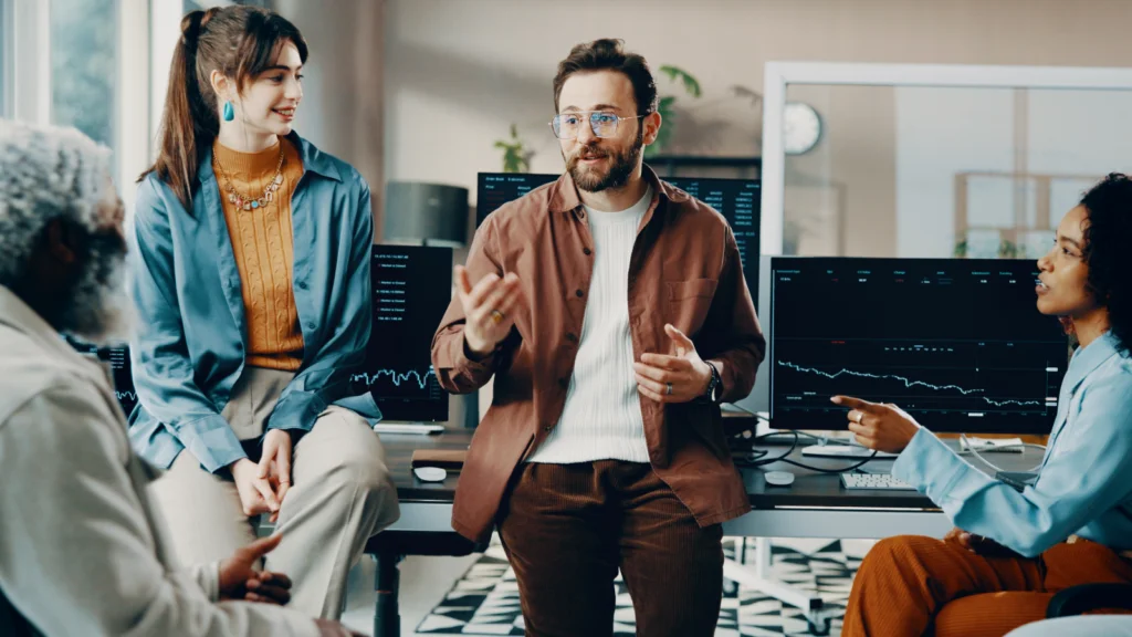 Three people engaged in conversation while sitting around a table.